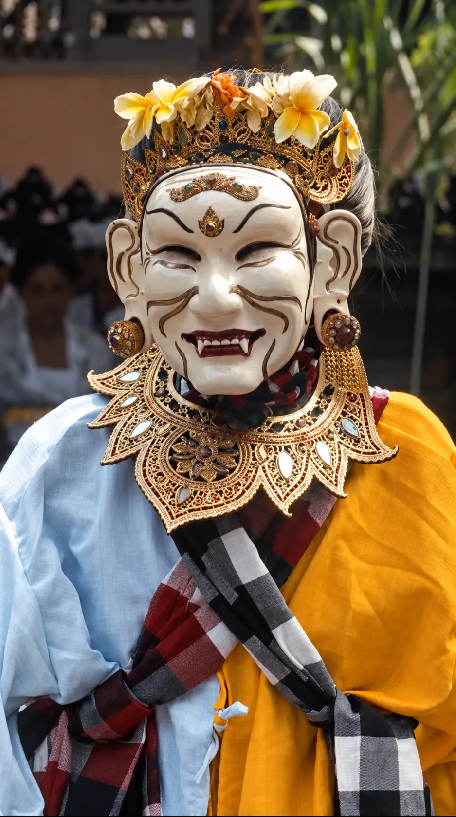 Balinese masked performer wearing ceremonial dress